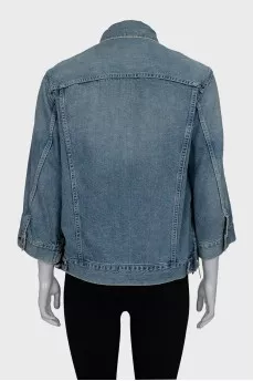 Denim jacket decorated with zippers