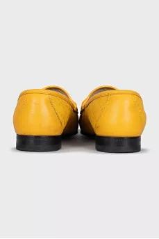 Yellow loafers with gold decor