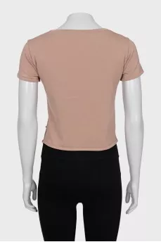 Cropped T-shirt decorated with perforations