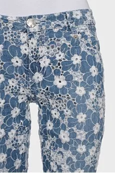 Jeans with perforations decorated with embroidery