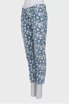 Jeans with perforations decorated with embroidery