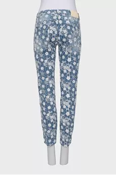 Jeans with perforations decorated with embroidery