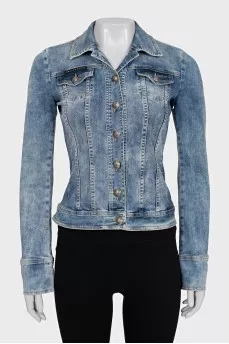 The denim jacket is decorated with rhinestones.