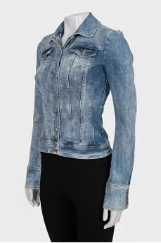 The denim jacket is decorated with rhinestones.