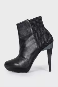 Black ankle boots with a relief pattern