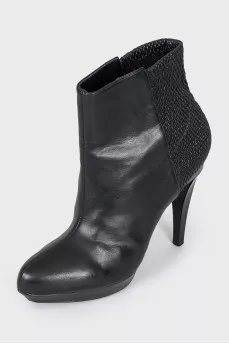 Black ankle boots with a relief pattern