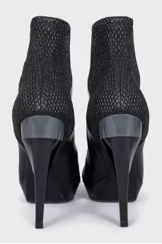 Black ankle boots with a relief pattern