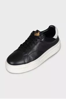 Black leather sneakers with white soles