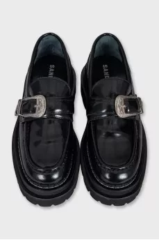 Black leather loafers with tag