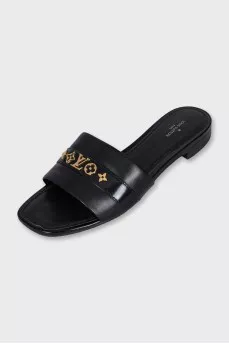 Black leather flip-flops with gold trim