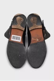 Black boots with a gold buckle