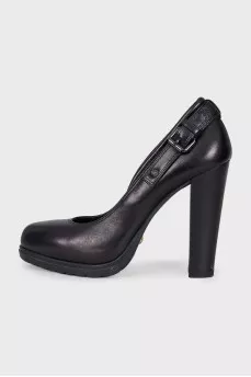 Black leather shoes decorated with buckles