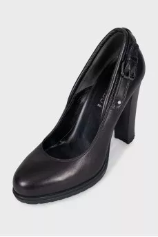 Black leather shoes decorated with buckles