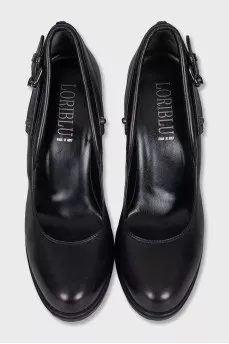 Black leather shoes decorated with buckles