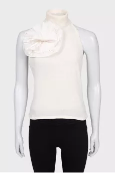 Beige top with an accent flower