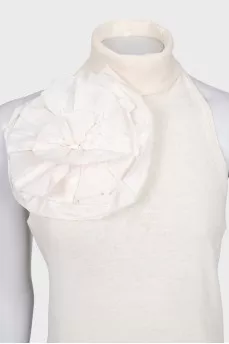 Beige top with an accent flower