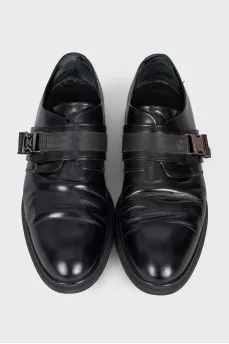 Men's leather shoes with decorative fastenings