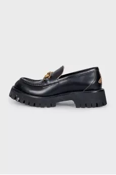 Black loafers with gold decor