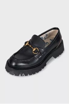 Black loafers with gold decor