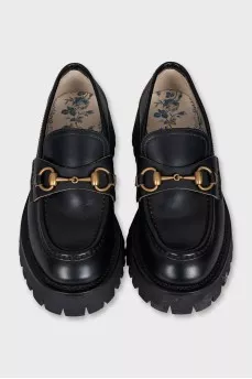 Black loafers with gold decor
