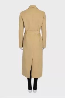 Beige coat with a signature brooch