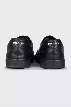 Men's black sneakers with a signature logo