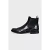Black leather boots with metallic decor