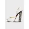 White sandals with striped heels