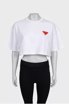 White top with a signature brooch