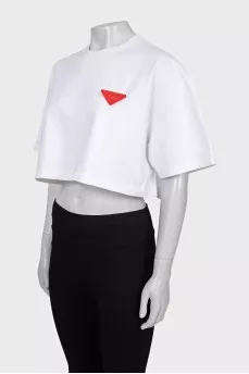 White top with a signature brooch