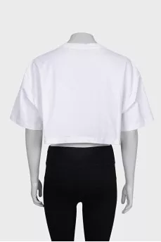 White top with a signature brooch