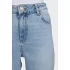 Light blue jeans with a tapered fit and a button fly