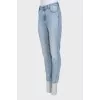 Light blue jeans with a tapered fit and a button fly