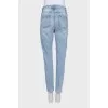 Light blue jeans with a tapered fit and a button fly
