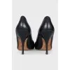 Black leather pumps