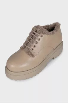 Beige fur-lined boots with a tag