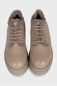 Beige fur-lined boots with a tag