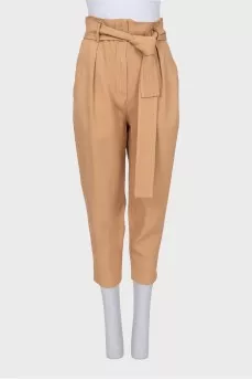 Beige tapered trousers with a belt