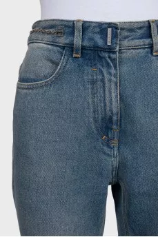 Blue jeans with a silver chain tag
