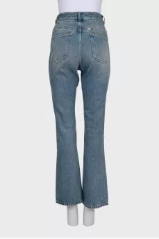 Blue jeans with a silver chain tag