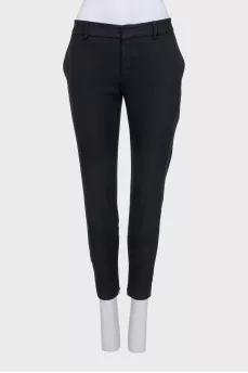 Tapered black trousers with a zip at the bottom