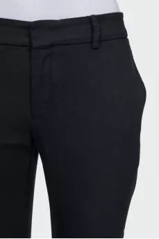 Tapered black trousers with a zip at the bottom