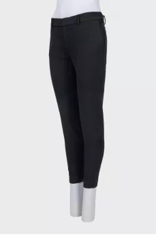 Tapered black trousers with a zip at the bottom