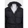 Black down jacket with zip pockets and tag
