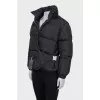 Black down jacket with zip pockets and tag