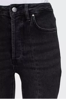 Black jeans decorated with slits