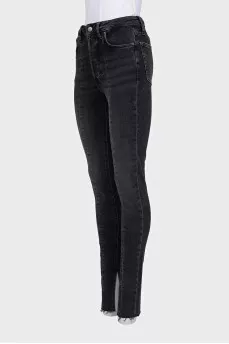 Black jeans decorated with slits