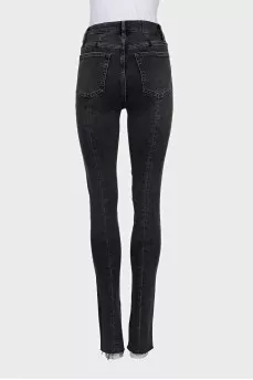 Black jeans decorated with slits