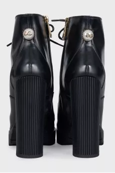 Black ankle boots with massive decor