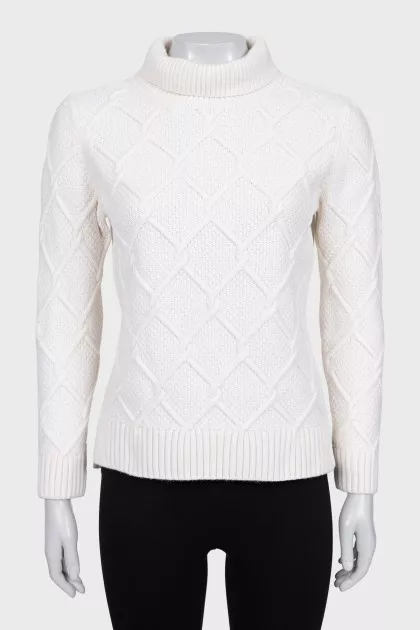 Knitted white sweater with a pattern